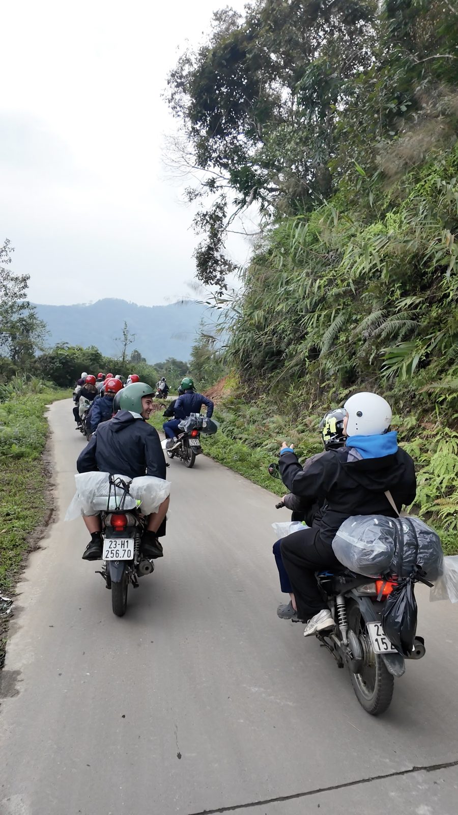 Group riding motorbikes through Ha Giang mountains